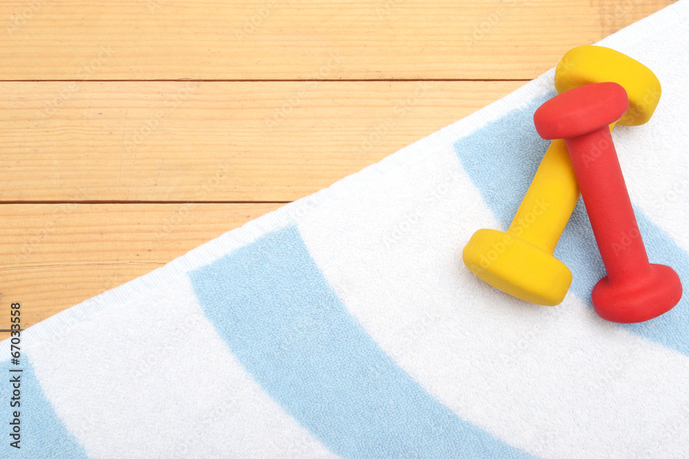 Dumbbells on the beach towel Dumbbells on the beach towel