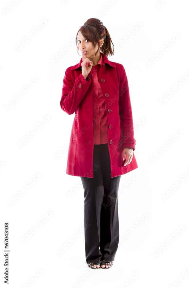 Indian young woman standing with finger on lips