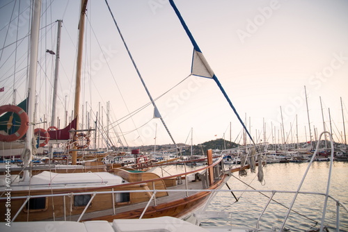 Marina with docked yachts at sunset © nickolya