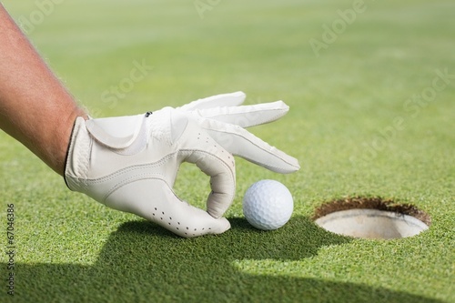 Golfer trying to flick ball into hole