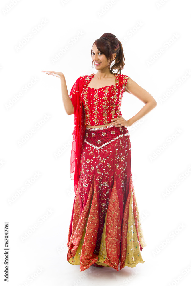 Young Indian woman showing product with open hand palm Young Indian woman showing product with open hand palm
