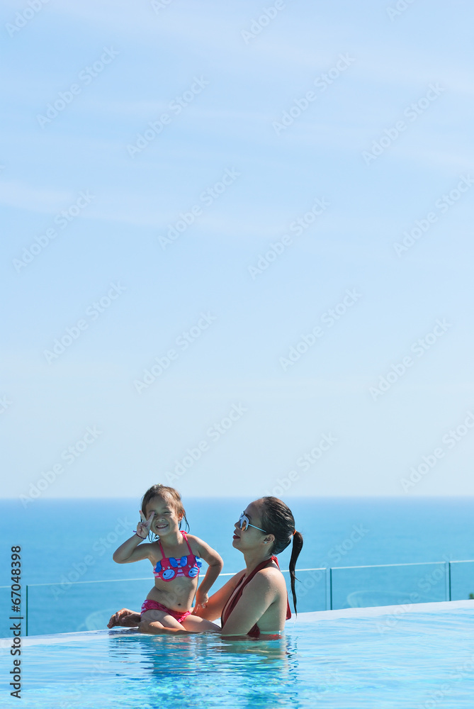 Summer vacations concept. Happy mother and daughter playing in b