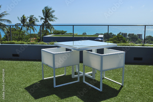 Photos Terrace lounge with white rattan armchairs and seaview in a luxu