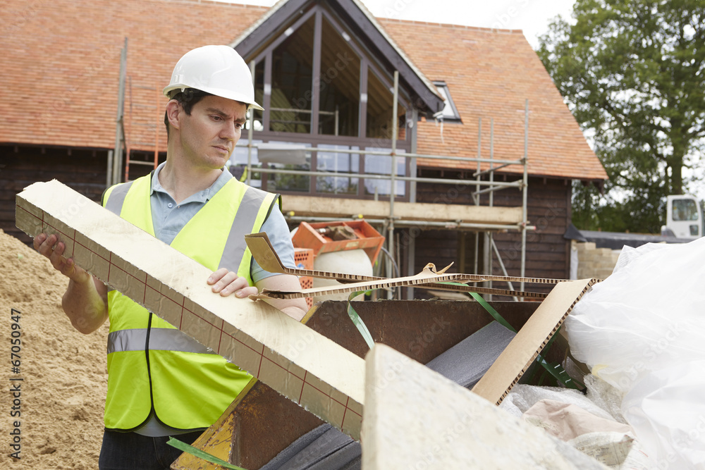 Builder Putting Waste Into Rubbish Skip Builder Putting Waste Into Rubbish Skip