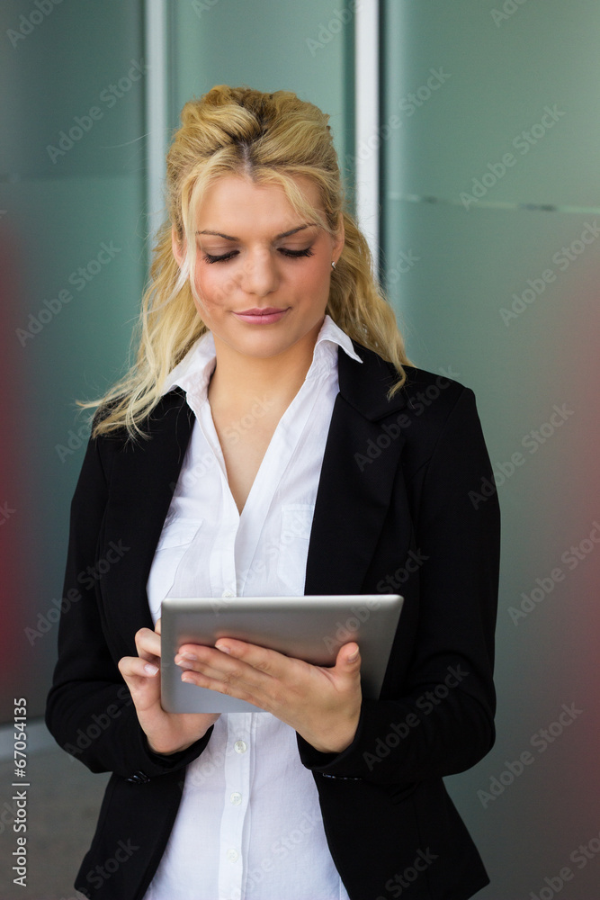 Portrait of smiling businesswoman with tablet PC at workplace Portrait of smiling businesswoman with tablet PC at workplace