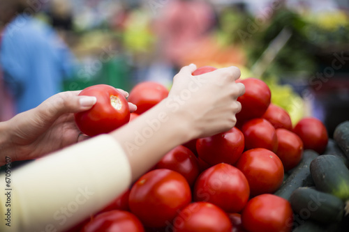 Woman buying vegetables on ...