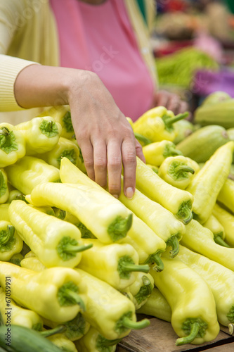 Woman buying vegetables on ...