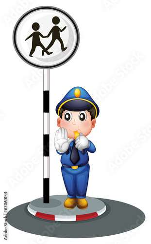 A policeman beside the street signage