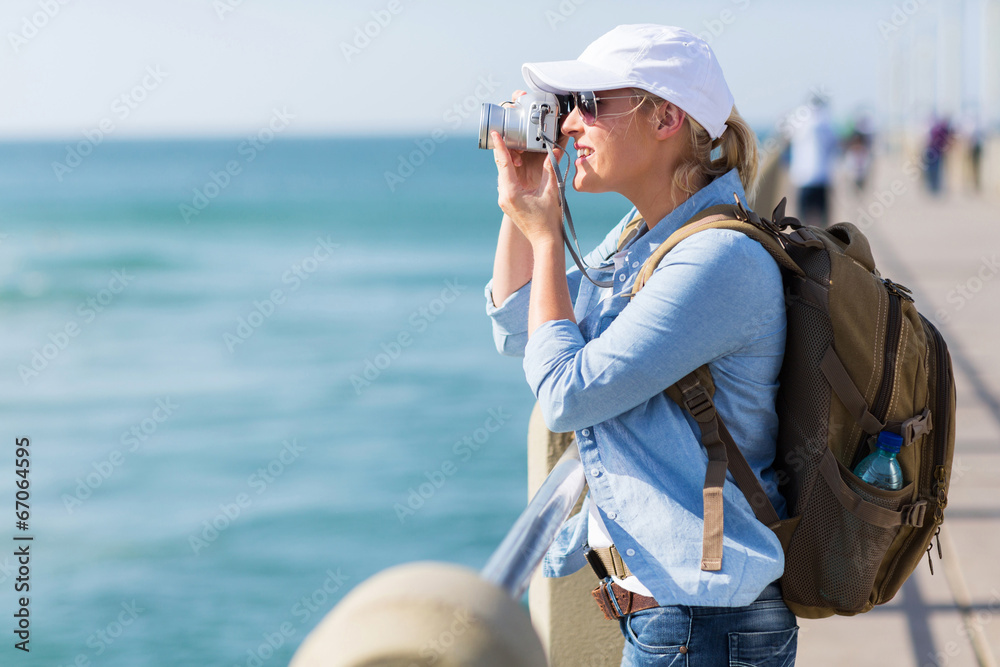 female tourist taking pictures on the pier