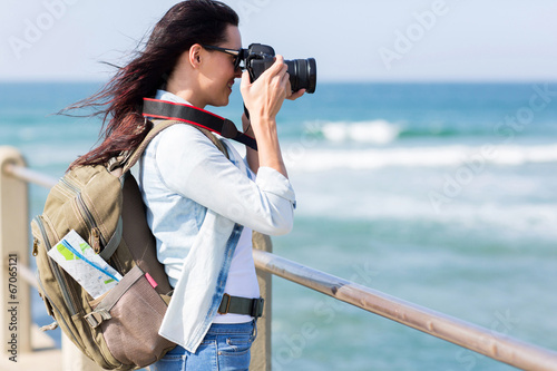 young tourist photographing at beach © michaeljung