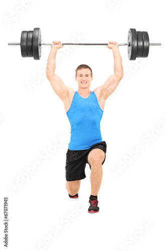 Male athlete holding a heavy weight and doing lunges
