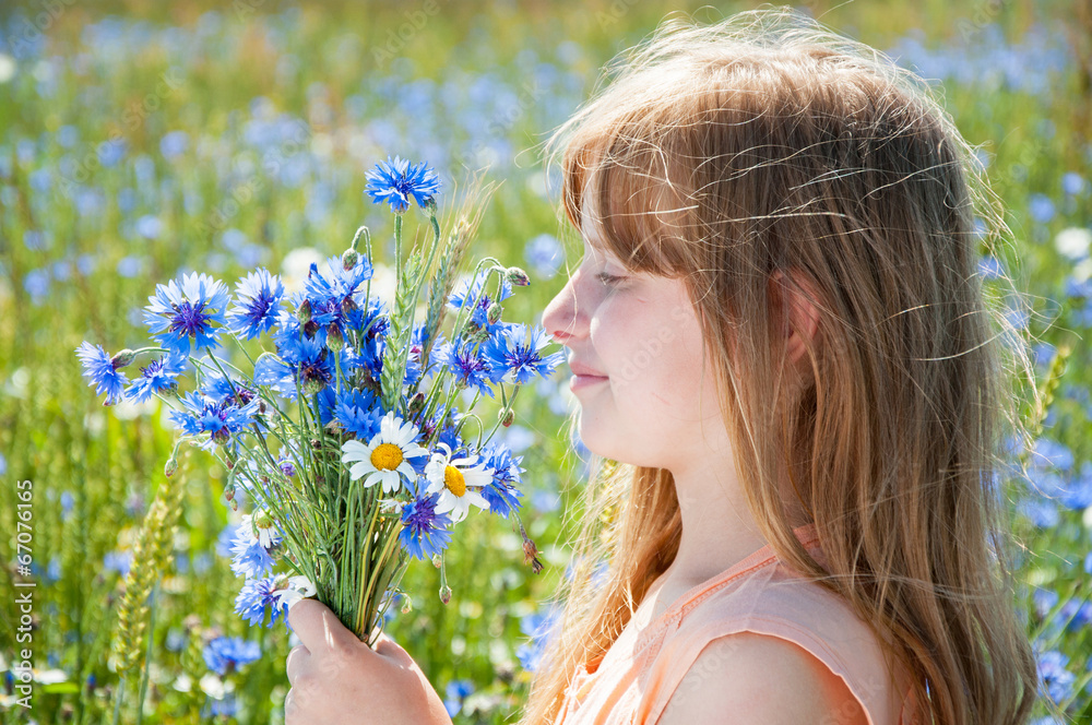 Smiling cute little girl with flowers on the meadow Smiling cute little girl with flowers on the meadow