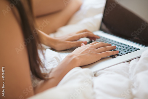 Typing on the laptop in bed