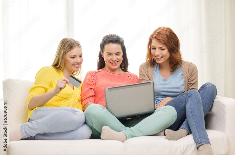 smiling teenage girls with laptop and credit card smiling teenage girls with laptop and credit card