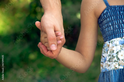 father holding daughter hand