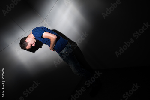 Young man suffering from severe belly pain photo