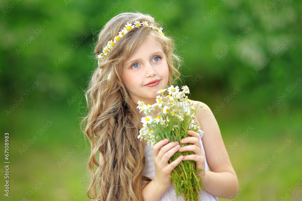 portrait of a beautiful little girl with chamomile