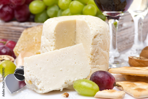 fresh cheese, crackers and grapes, close-up