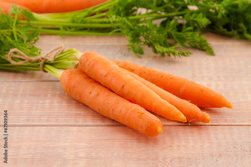 Fresh organic carrots with their tops Fresh organic carrots with their tops