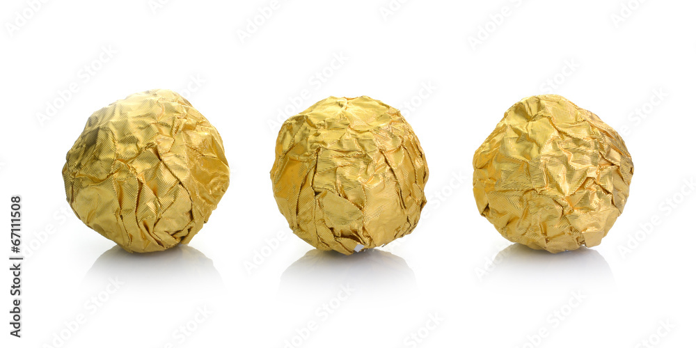 Chocolate ball with almond in a gold foil paper. Chocolate ball with almond in a gold foil paper.