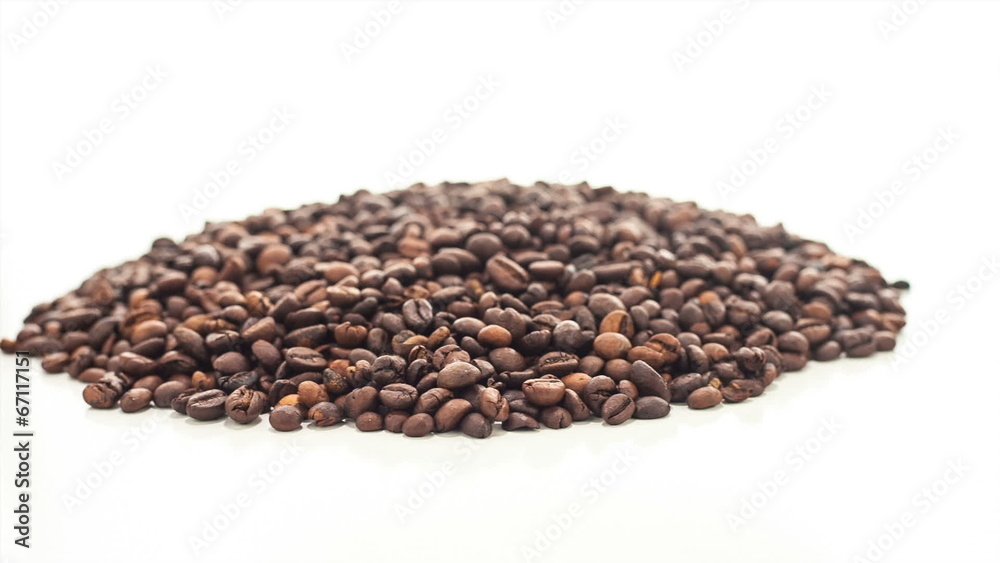 Heap of roasted coffee beans being rotated on white background Heap of roasted coffee beans being rotated on white background