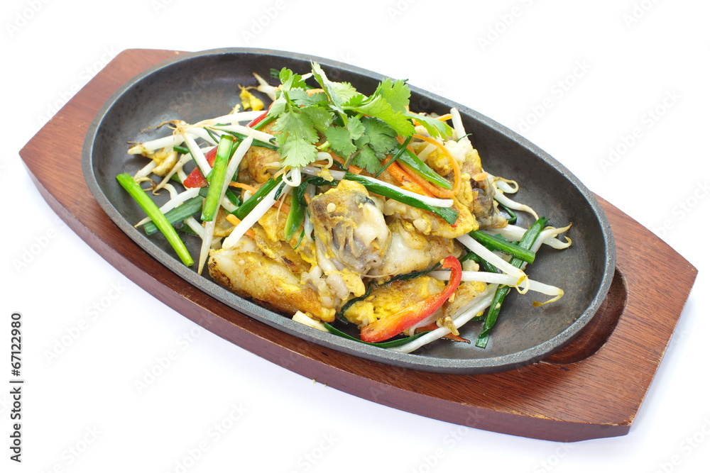 fried mussel pancakes and vegetables in hot plate fried mussel pancakes and vegetables in hot plate