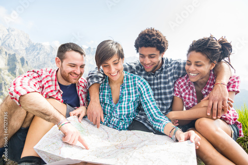 Hikers Looking at Map on top of Mountain