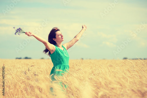 Woman enjoying the sun on wheat field © Anatoliy Sadovskiy