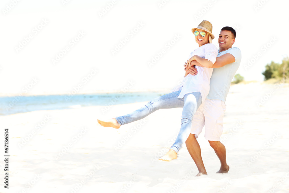 Happy couple having fun at the beach Happy couple having fun at the beach
