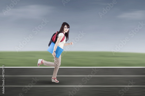 Student running on tracks © Creativa Images