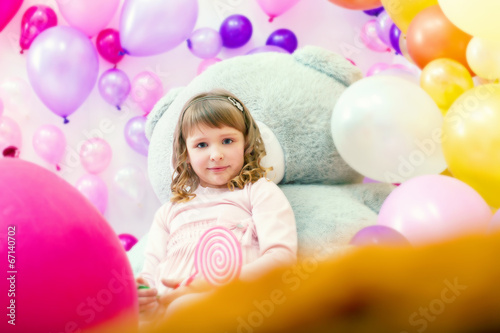 Cute girl posing in playroom on balloons backdrop © Wisky
