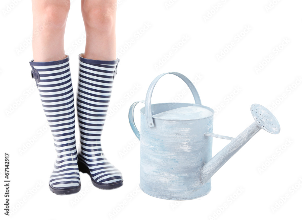 Young woman in rubber boots with watering can, isolated on