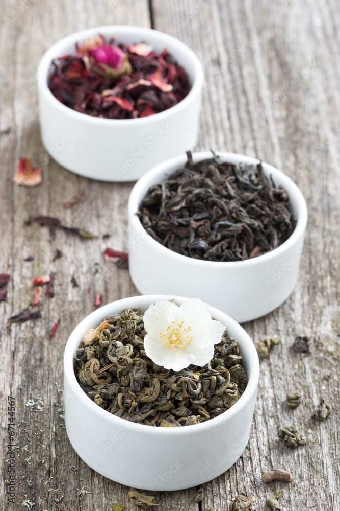 Assorted dry herbal teas in white bowls, vertical Assorted dry herbal teas in white bowls, vertical