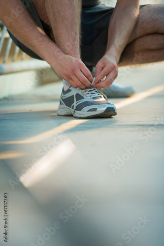 Man lacing shoes