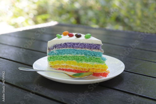 Multicolored peace of cake decorated with sweets