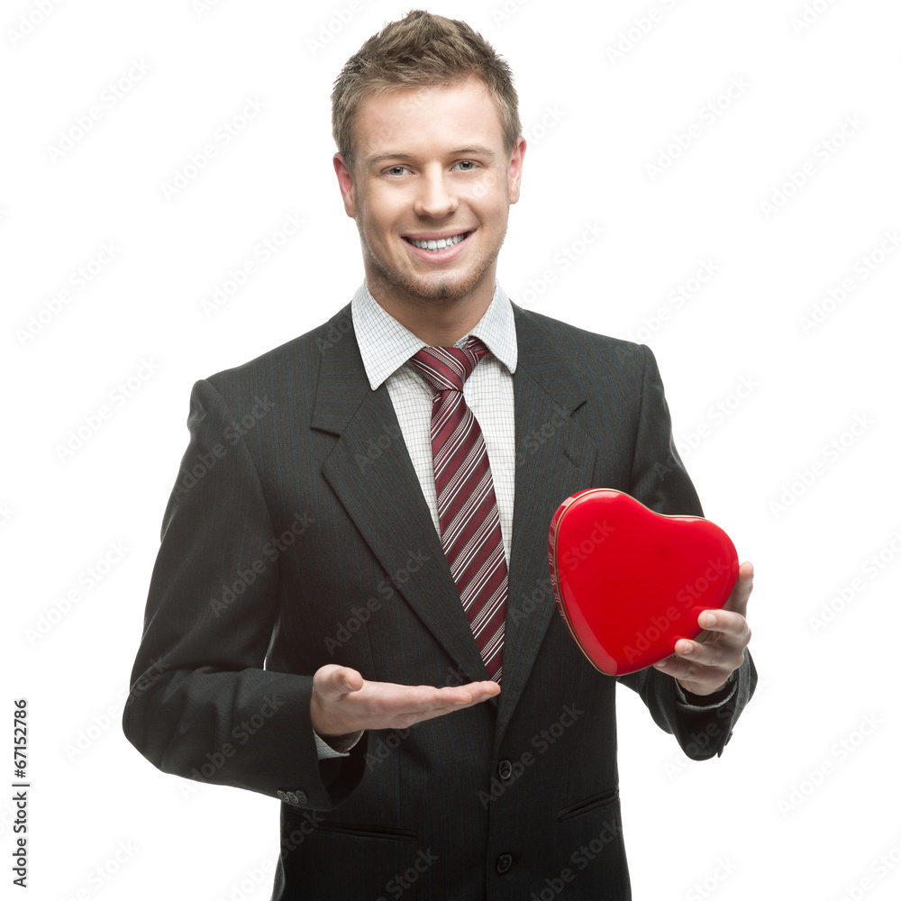 young cheerful businessman holding red heart young cheerful businessman holding red heart