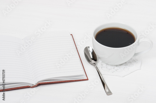 Notebook Mock Up And Cup Of Coffee On White Painted Wooden Desk