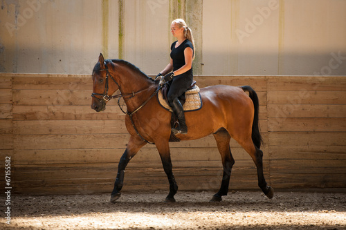 Beautiful young blonde woman riding a horse © Samo Trebizan