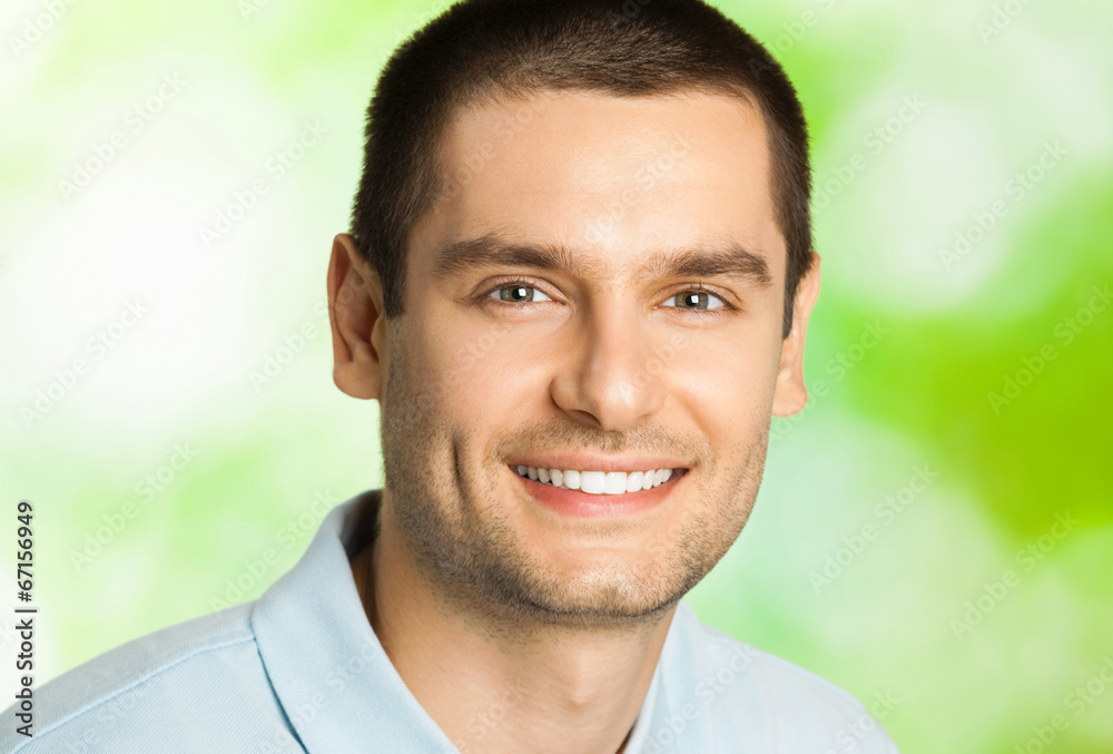 Happy smiling man with plate of salad, outdoors Happy smiling man with plate of salad, outdoors