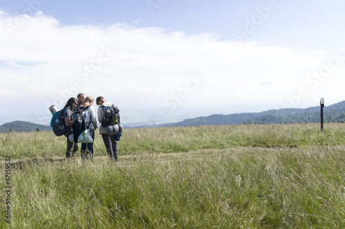 A group of friends on mountain path, Gorce Mountains, Poland © Piotr Szpakowski