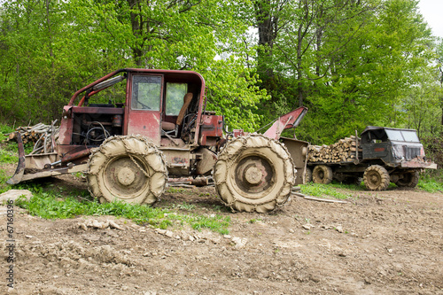 Bulldozer and old truck in a forest