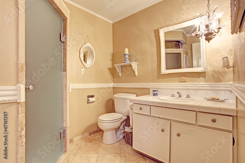 Soft ivory empty bathroom interior in old house