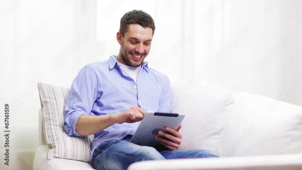 smiling man working with tablet pc at home smiling man working with tablet pc at home