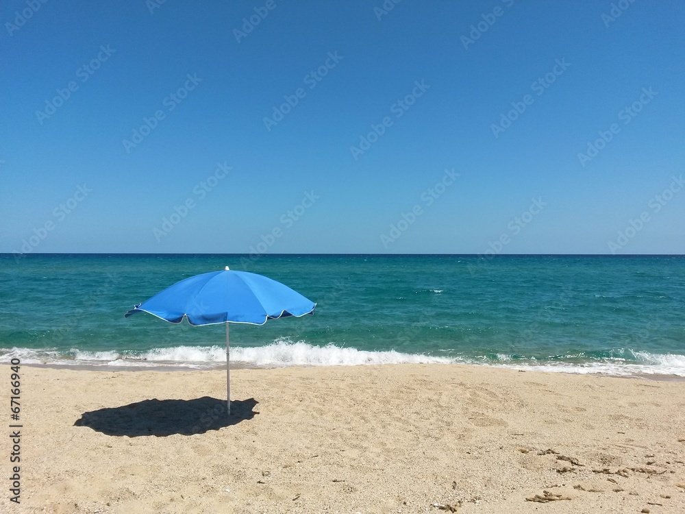 lonely sun umbrella on the beach
