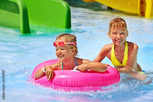 Children sitting on inflatable ring.