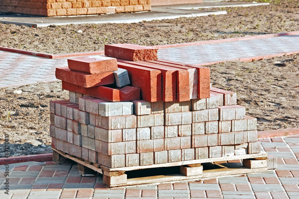 Obraz premium Stack of orange clay brick on construction site