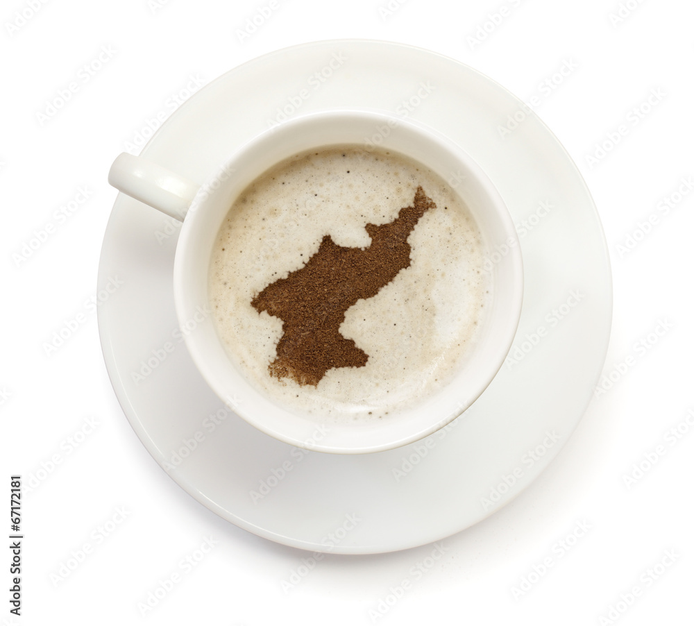 Cup of coffee with foam and powder in the shape of North Korea.( Cup of coffee with foam and powder in the shape of North Korea.(