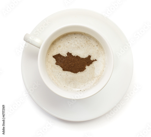 Cup of coffee with foam and powder in the shape of Mongolia.(ser