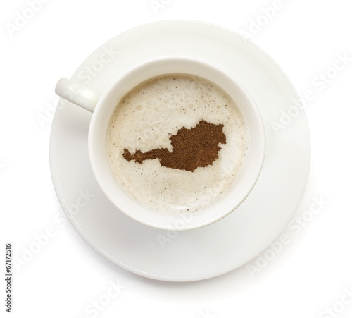 Cup of coffee with foam and powder in the shape of Austria.(seri