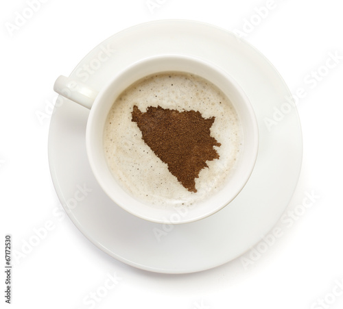 Cup of coffee with foam and powder in the shape of Bosnia and He